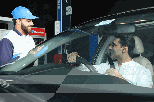 Service attendant and driver talking inside car